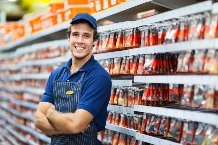 28965402 - handsome hardware store salesman standing next to fasteners shelf 28965402 - handsome hardware store salesman standing next to fasteners shelf