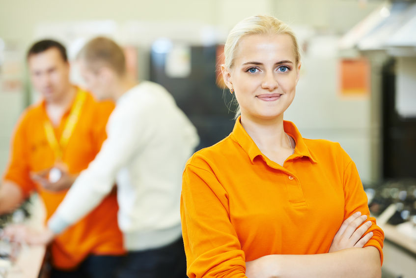 Seller assistant in shop Positive seller or shop assistant portrait in supermarket store