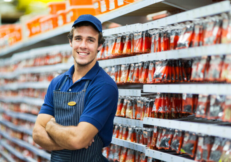 28965402 - handsome hardware store salesman standing next to fasteners shelf 28965402 - handsome hardware store salesman standing next to fasteners shelf