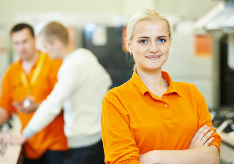 Seller assistant in shop Positive seller or shop assistant portrait in supermarket store